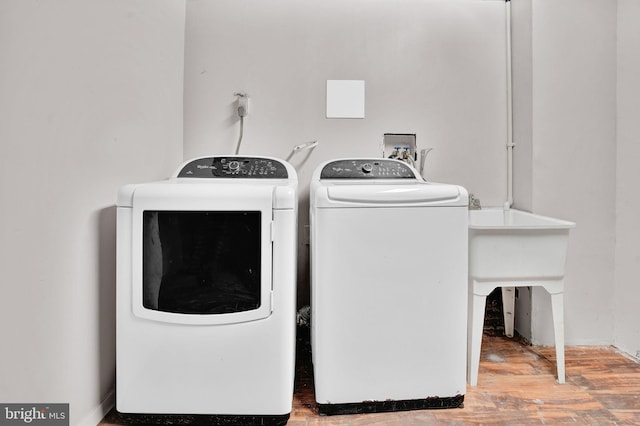 laundry area featuring laundry area, washer and dryer, and wood finished floors