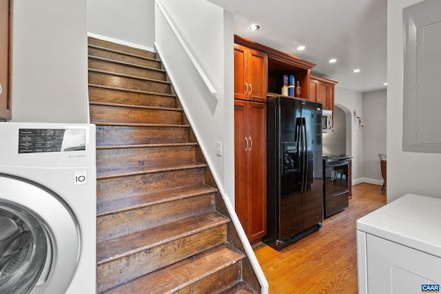 stairway with washer / dryer, baseboards, arched walkways, wood finished floors, and recessed lighting