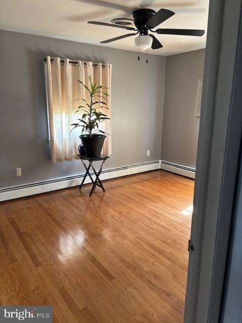 unfurnished room with a ceiling fan and wood finished floors