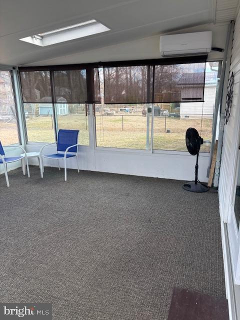 unfurnished sunroom with a wall mounted air conditioner