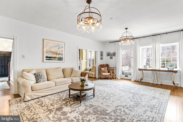 living area featuring a notable chandelier and hardwood / wood-style flooring