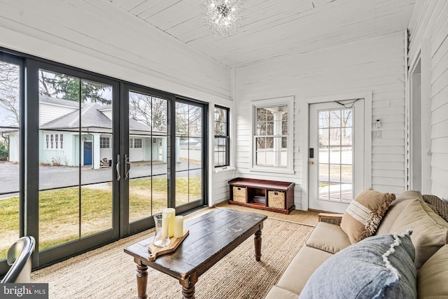 sunroom with wooden ceiling and a notable chandelier