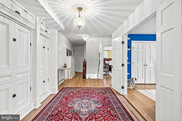 entryway featuring baseboards and wood finished floors