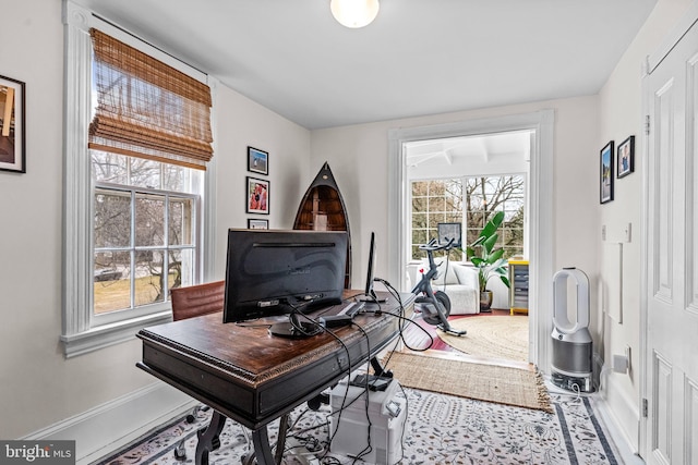 home office featuring a healthy amount of sunlight and baseboards