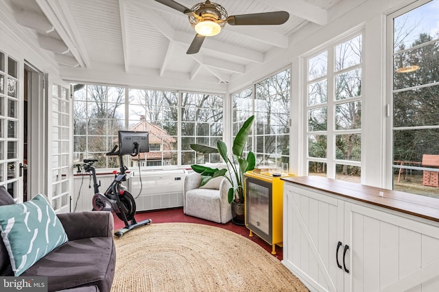 sunroom / solarium with ceiling fan and beamed ceiling