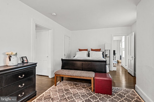 bedroom featuring baseboards and wood finished floors