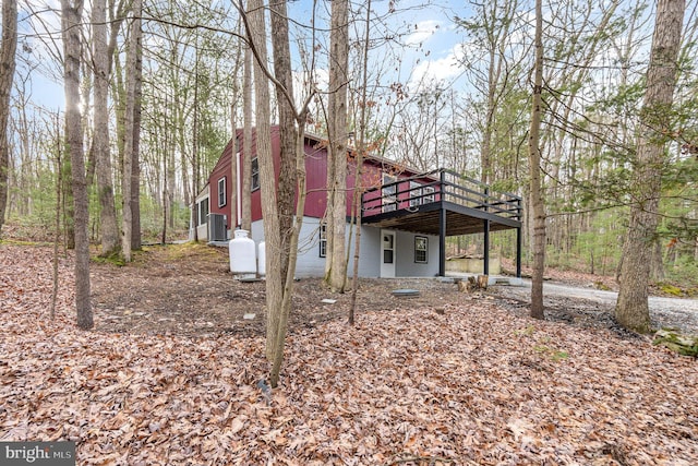 exterior space featuring a carport, a deck, and central AC