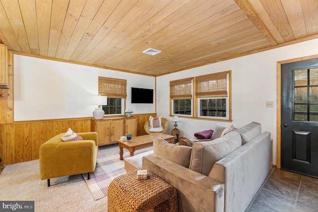 living area featuring a wainscoted wall, wood walls, wooden ceiling, and visible vents