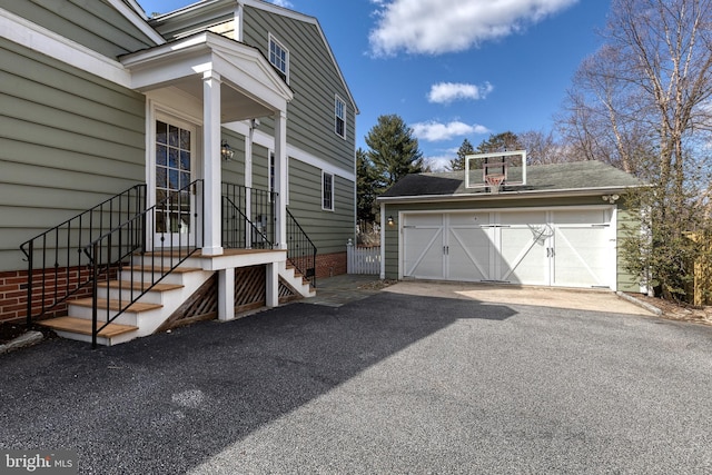 view of side of home featuring a garage and an outdoor structure