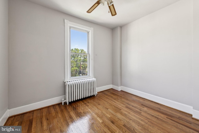 1306 E St NE, Washington, DC 20002 - empty room featuring radiator heating unit, baseboards, wood finished floors, and ceiling fan