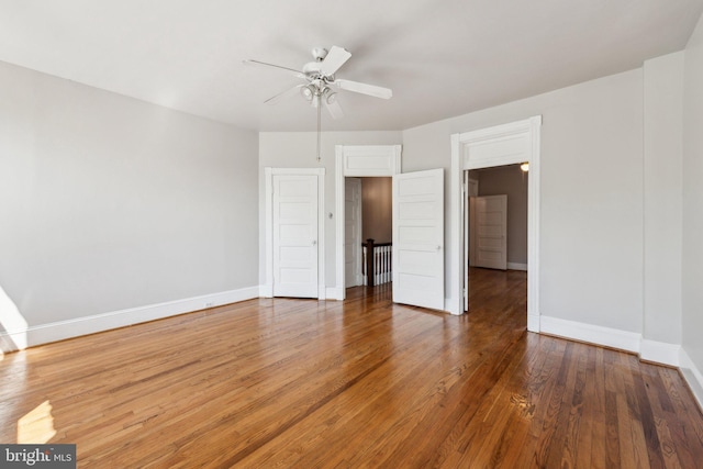 1306 E St NE, Washington, DC 20002 - unfurnished bedroom featuring baseboards, wood finished floors, and a ceiling fan