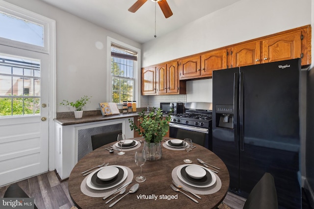 1306 E St NE, Washington, DC 20002 - kitchen with black appliances, dark wood-style floors, a ceiling fan, brown cabinets, and dark countertops