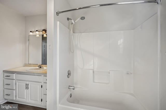 bathroom featuring vanity and  shower combination