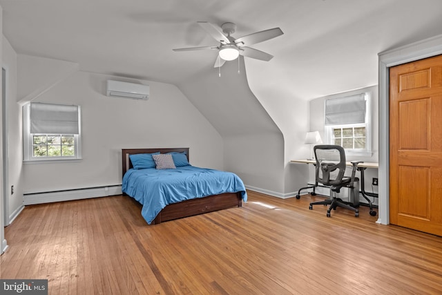 bedroom featuring multiple windows, baseboard heating, a wall mounted air conditioner, and hardwood / wood-style flooring