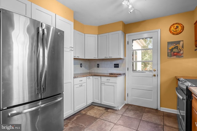 kitchen with white cabinets, baseboards, stainless steel appliances, and decorative backsplash