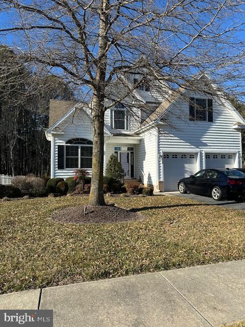 view of front of property featuring aphalt driveway, an attached garage, and a chimney