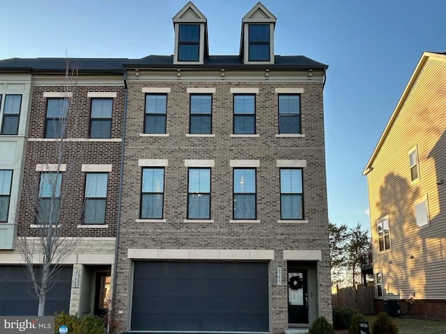 view of front of house with a garage, brick siding, and driveway