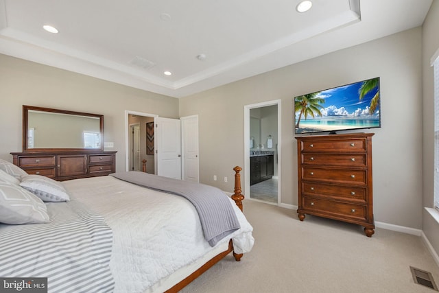 bedroom featuring a tray ceiling, recessed lighting, light colored carpet, visible vents, and baseboards