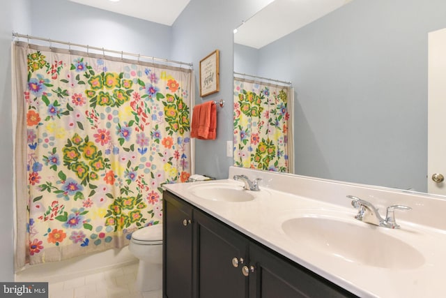 full bath with double vanity, shower / bath combination with curtain, a sink, and toilet