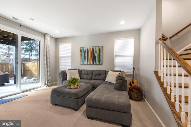 living room with carpet, recessed lighting, visible vents, baseboards, and stairs