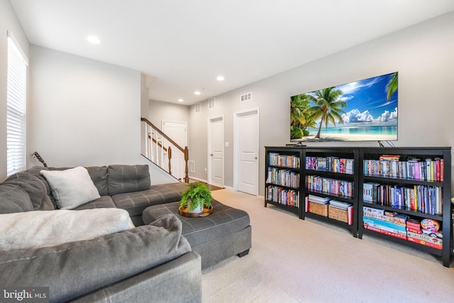 living room with recessed lighting, carpet flooring, visible vents, and stairs