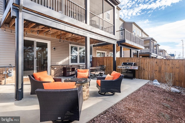 view of patio featuring outdoor lounge area, a grill, and fence