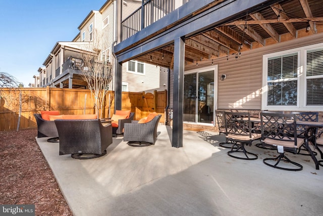 view of patio / terrace featuring outdoor lounge area and fence