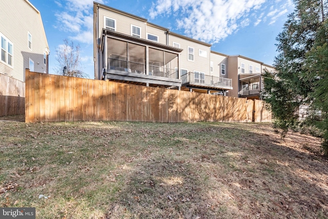 rear view of property featuring fence