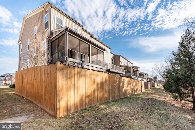 view of property exterior featuring a residential view and a sunroom