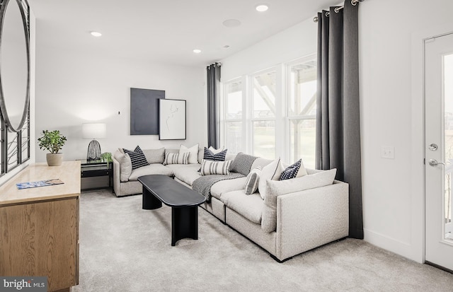 living room featuring light carpet, baseboards, and recessed lighting