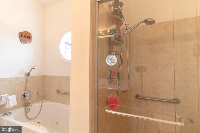 bathroom featuring a jetted tub and a shower stall