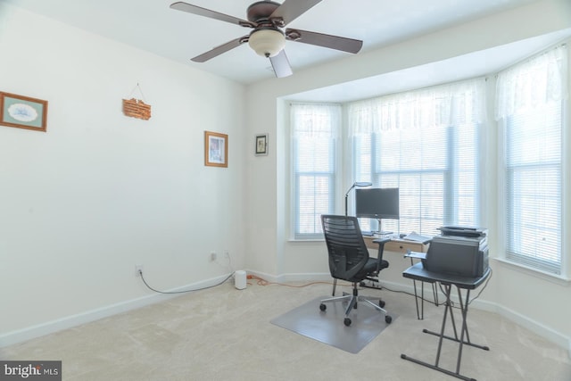 home office with baseboards, a ceiling fan, and carpet flooring