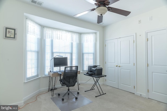 office area with carpet flooring, a healthy amount of sunlight, visible vents, and baseboards