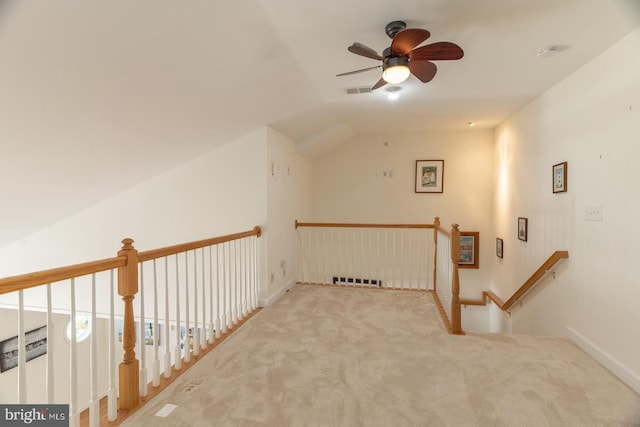 additional living space featuring visible vents, lofted ceiling, and carpet