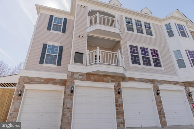 multi unit property with a balcony and a garage