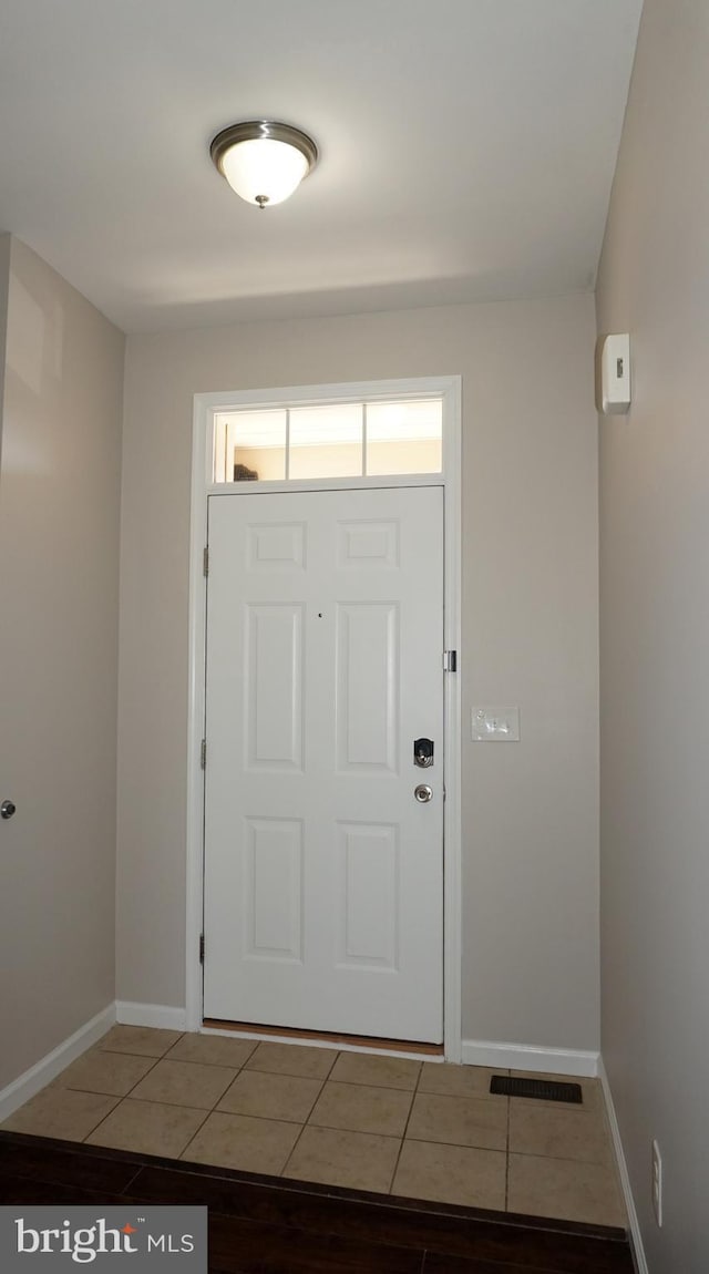 entryway featuring tile patterned floors and baseboards