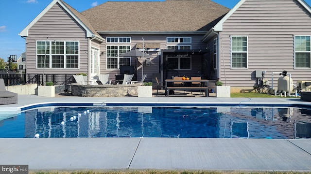 view of swimming pool featuring a fenced in pool, a patio, an outdoor hangout area, and fence