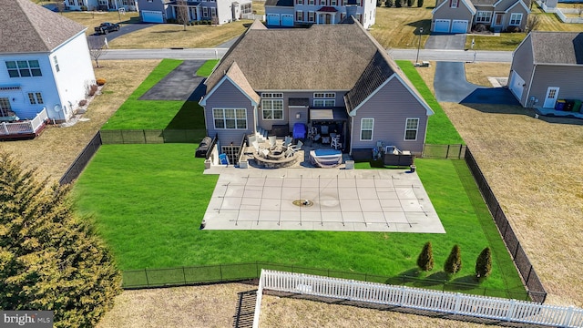 back of house featuring a patio area, fence, and a residential view