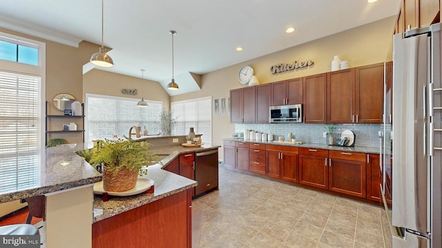 kitchen with a sink, tasteful backsplash, stainless steel appliances, light stone countertops, and hanging light fixtures