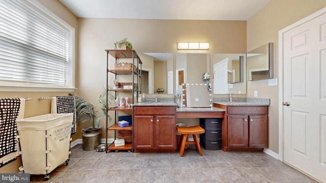 bathroom with baseboards and vanity