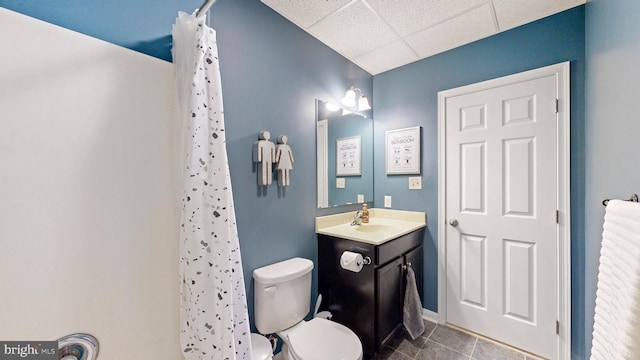 full bath featuring vanity, a paneled ceiling, curtained shower, tile patterned floors, and toilet