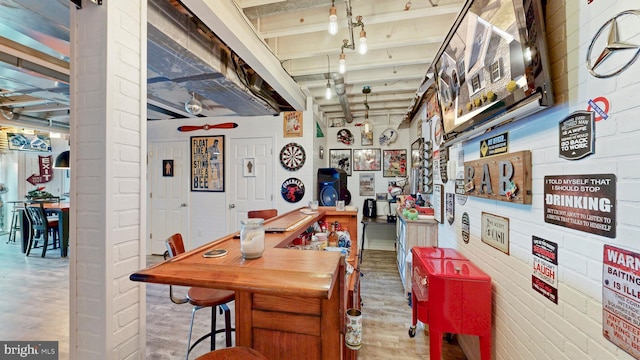 interior space featuring brick wall and ceiling fan