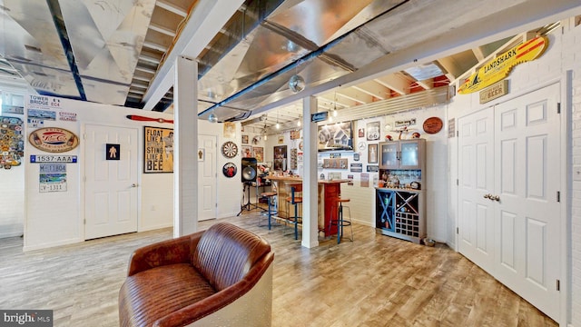 basement featuring light wood-style flooring