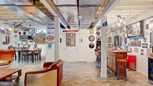 interior space featuring a dry bar and wood finished floors