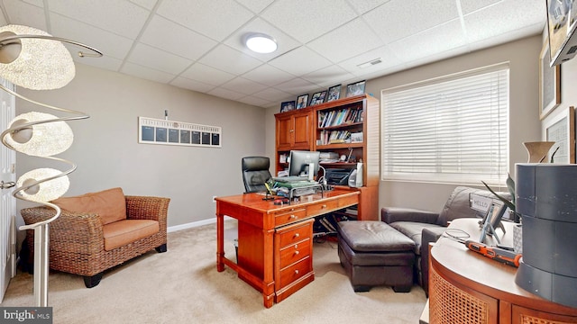 home office with light carpet, visible vents, a paneled ceiling, and baseboards