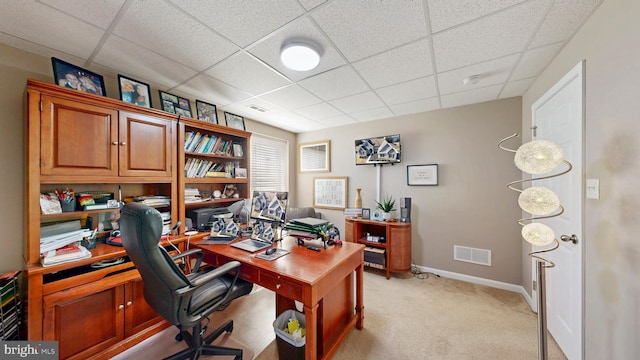 office space with light colored carpet, visible vents, a drop ceiling, and baseboards