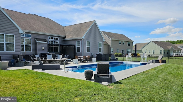 view of pool with a yard, a patio, a fire pit, and fence