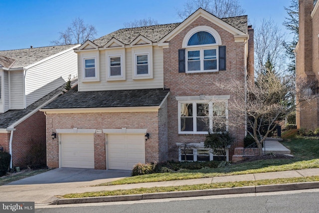 traditional-style home with a garage, concrete driveway, and brick siding