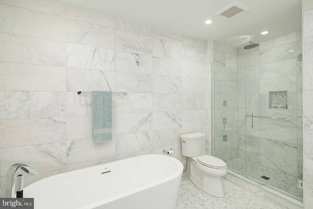 full bathroom featuring toilet, visible vents, tile walls, a soaking tub, and a shower stall