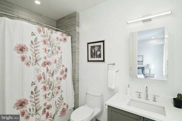 bathroom with toilet, a shower with shower curtain, and vanity